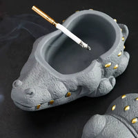 Cendrier crocodile ouvert avec un mégot